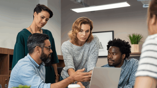 Diverse people around laptop - A new, better way think about translation quality in 2025